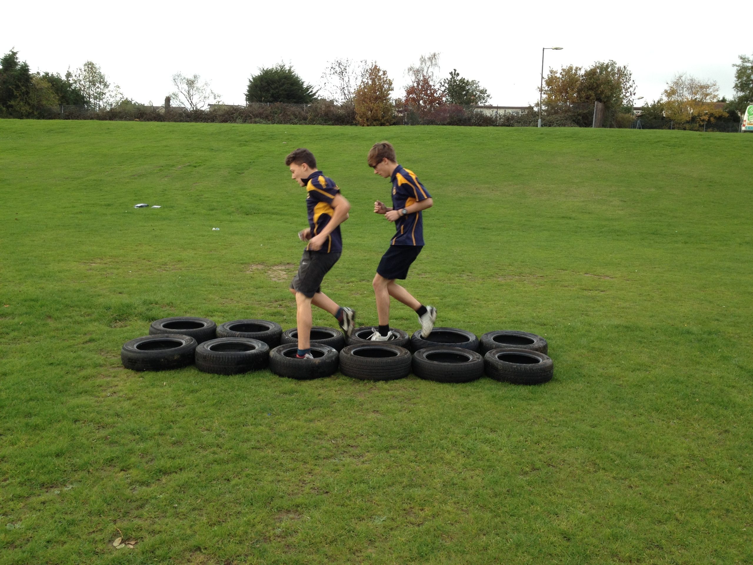 Children Jumping Through Tires