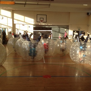 Children Playing Zorb Football On Sports Day